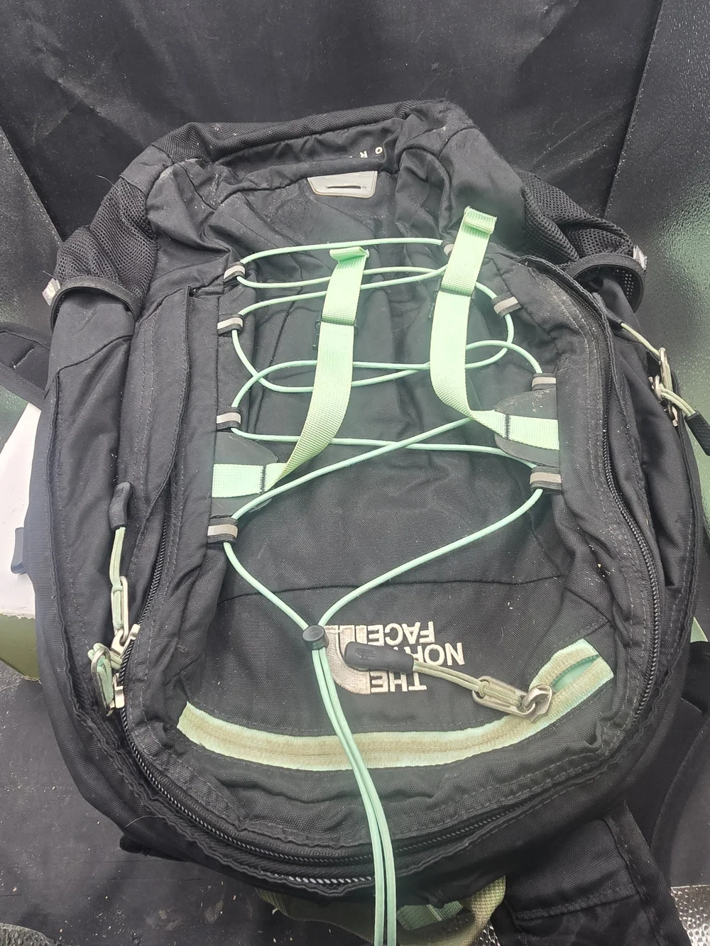 The North Face Black Backpack with Mint Green Bungee and Straps